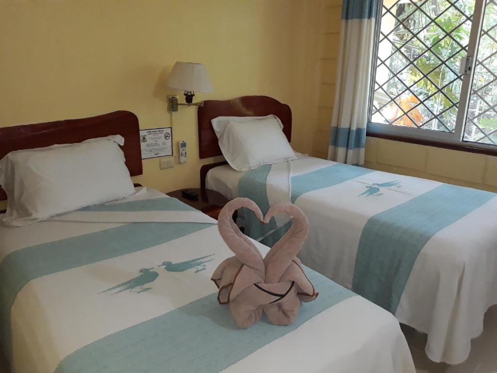 Postel nebo postele na pokoji v ubytování Hotel - Museo Xibalba