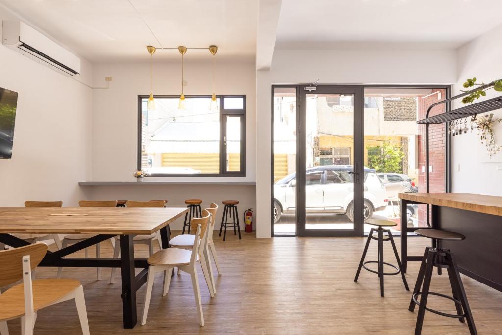 a dining room with a table and chairs at Nice Hostel in Magong