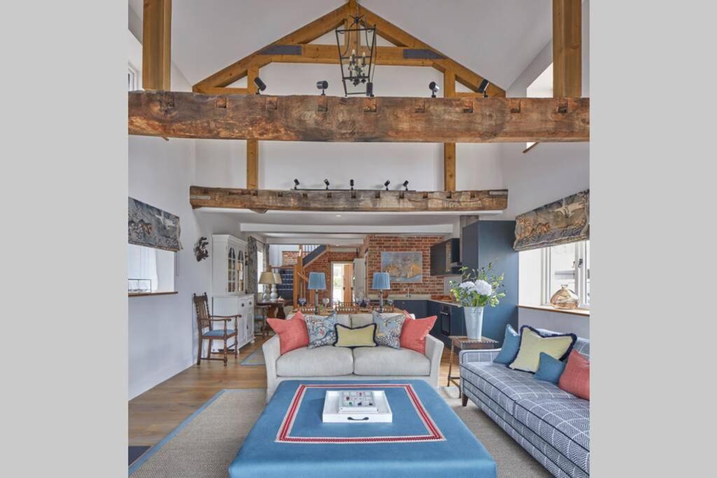 a living room with a couch and a table at The Barn in Devizes