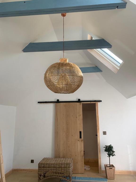 a pendant light hanging from the ceiling in a room at Mauds Washhoose@The Smithy in Bargany