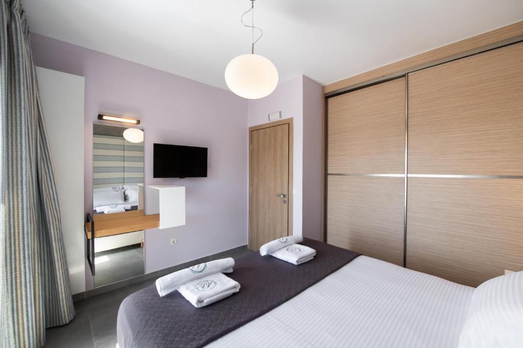 Łóżko lub łóżka w pokoju w obiekcie Aelia Suites