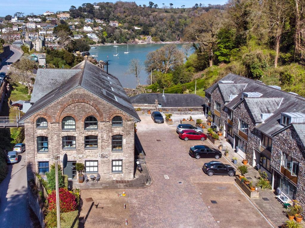 an old stone building with cars parked in a parking lot at 8 The Pottery in Dartmouth