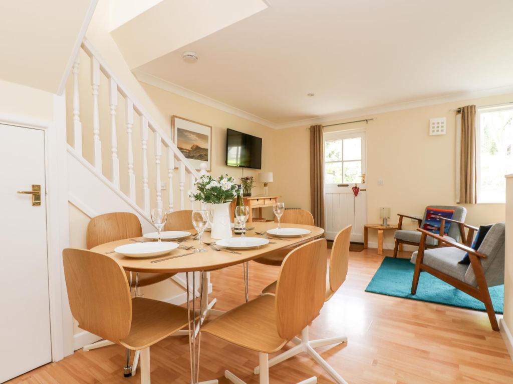 a dining room with a table and chairs at Pugwash Cottage in Falmouth
