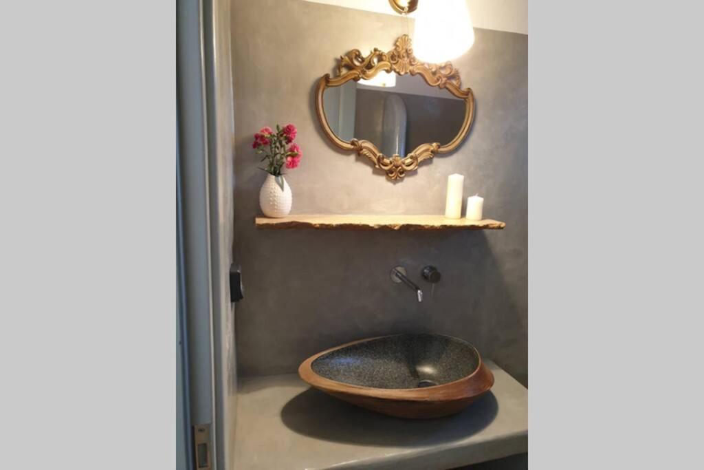 a bathroom with a wooden sink and a mirror at Patmos Little Suites in Skala