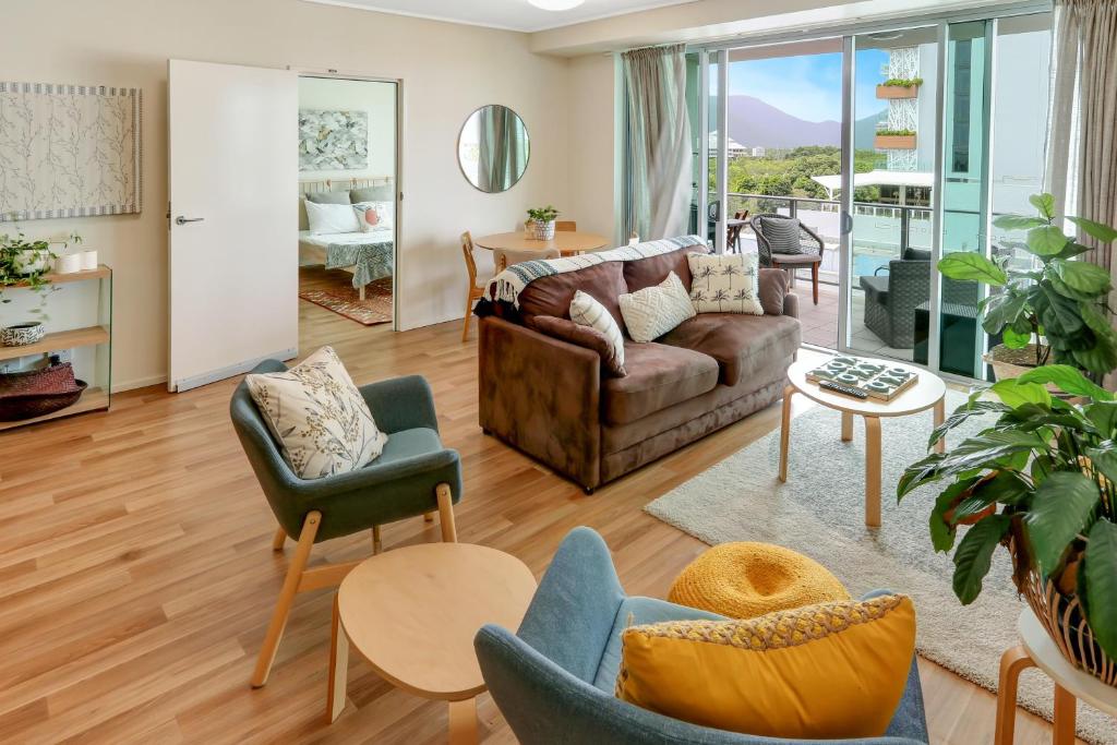 a living room with a couch and chairs at The Harbour View Condo in Cairns