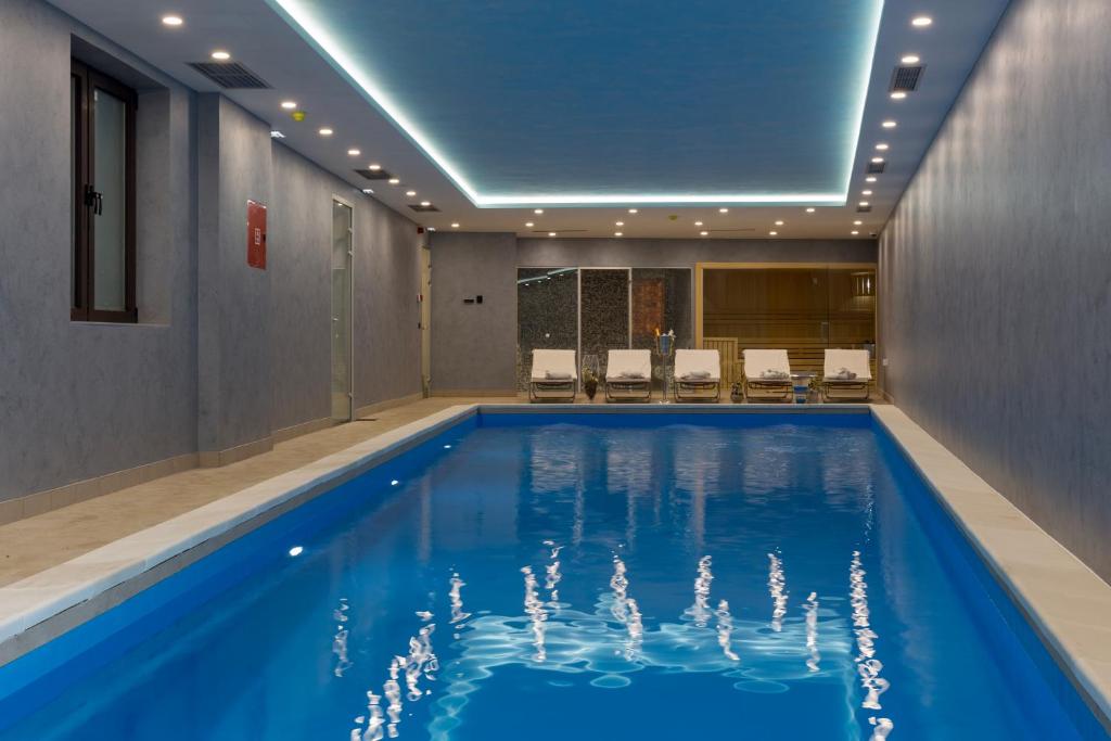 a pool in a hotel room with a swimming pool at Hotel MIR in Zlatibor