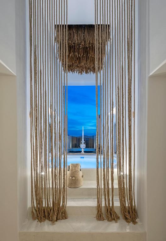 a room with a window with a view of the ocean at Evais Boutique Houses & Luxury Suites in Karistos