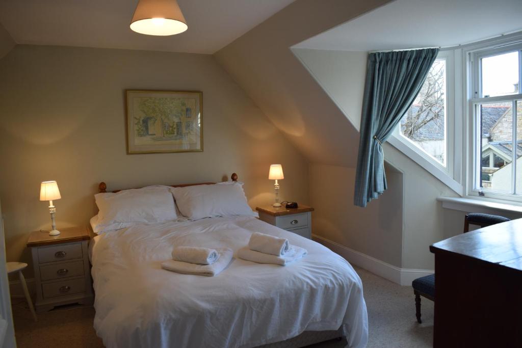 a bedroom with a bed with two pillows on it at 3 St Gilbert Street in Dornoch