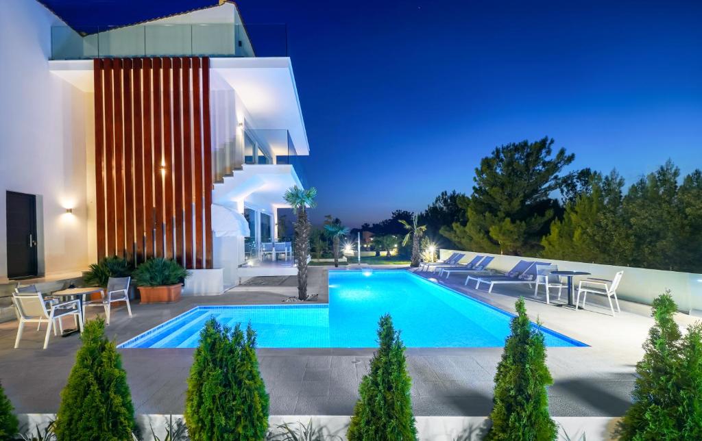 a swimming pool in the backyard of a house at Hotel ASTERA in Skala Rachoniou