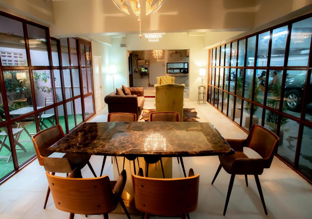 a dining room with a table and chairs at RoomQuest Bangkok Ratchada in Bangkok