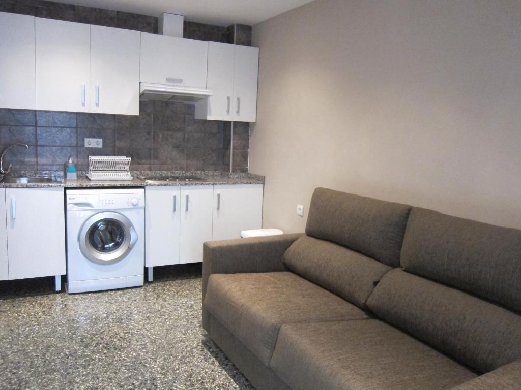 a living room with a couch and a washing machine at Apartamentos Abastos in Valencia