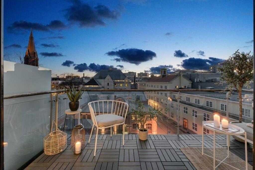 a balcony with a table and chairs and a view of a city at Awardwinning penthouse, Oslo city / Grünerløkka in Oslo