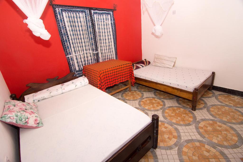 Postel nebo postele na pokoji v ubytování First Point Arusha Hostel