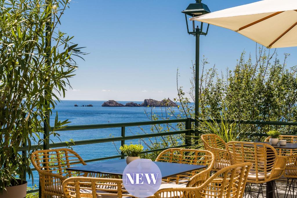 a table and chairs with the ocean in the background at Art Hotel Dubrovnik in Dubrovnik