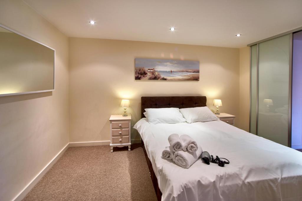Un dormitorio con una cama con zapatos. en The Paramount, Swindon en Swindon
