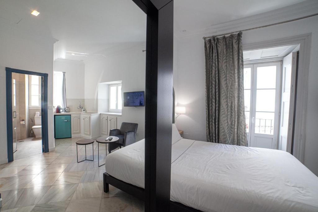 Postel nebo postele na pokoji v ubytování Apartahotel Siglo XIX
