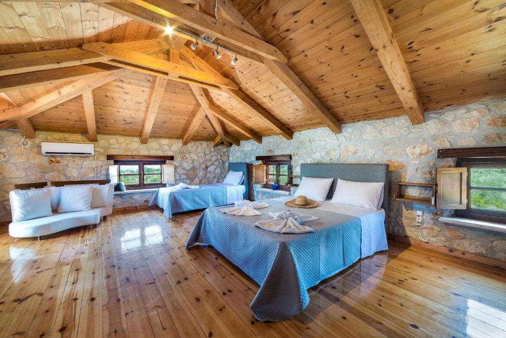 a room with two beds and a table in it at Abeloklima superior apartment in Vasilikos