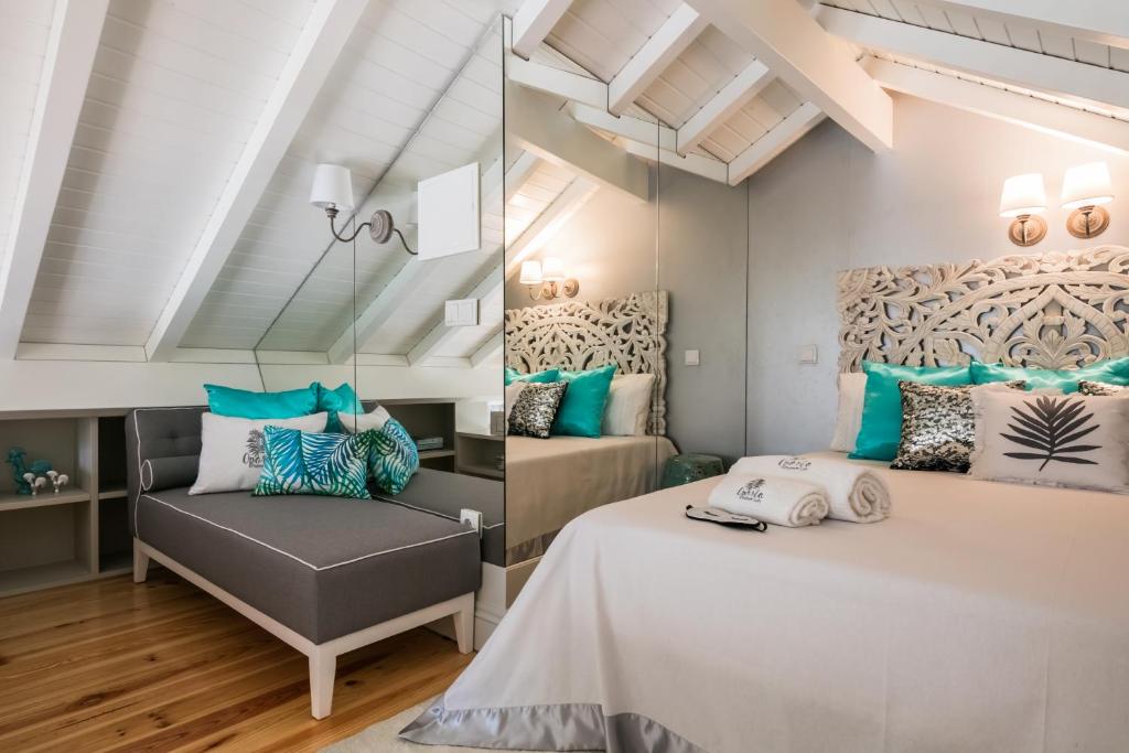 a bedroom with a bed and a chair at Oporto Platinum Loft in Porto