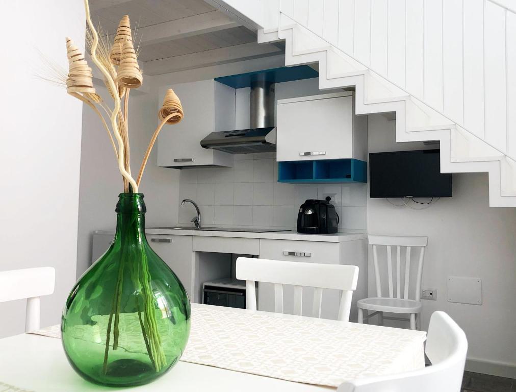 a green vase sitting on a table in a kitchen at Casa Toti in Matino