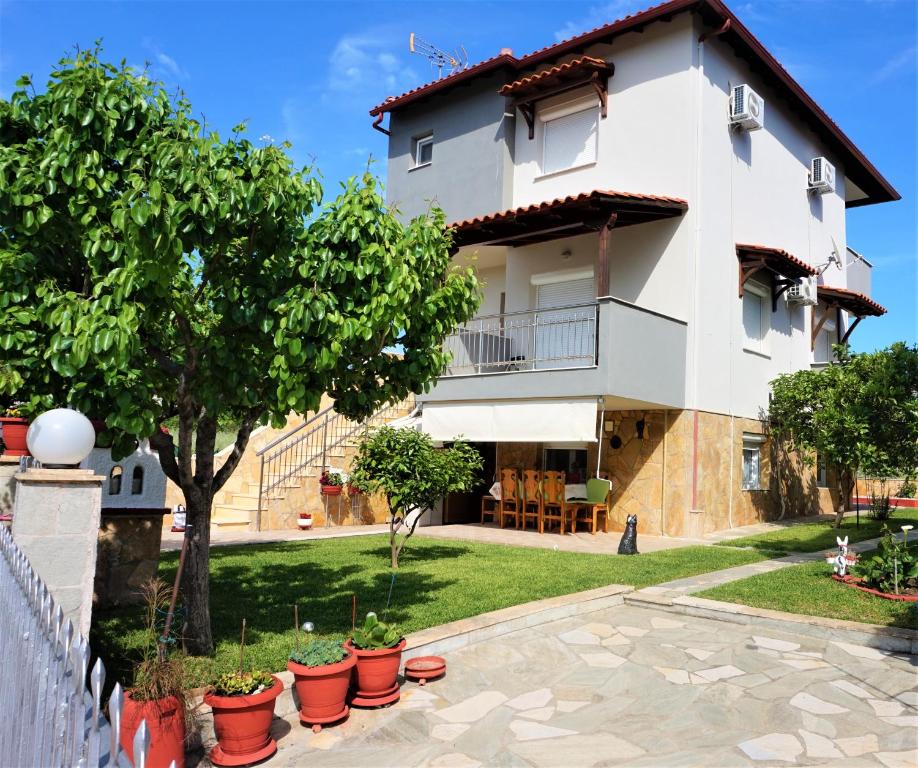 a villa with a garden and a house at Katerinas House in Nikiti