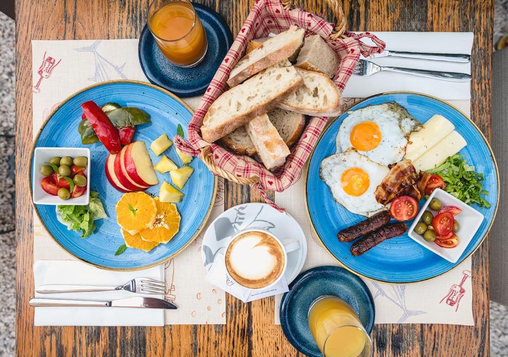 a table topped with plates of breakfast foods and coffee at Stayeva 11 in Dubrovnik
