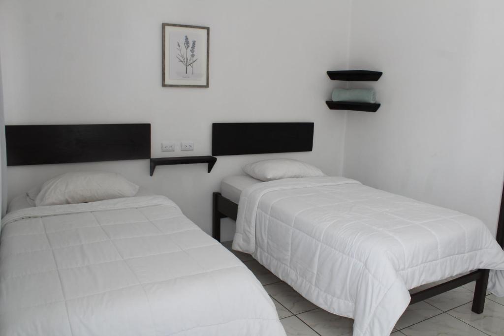 Postel nebo postele na pokoji v ubytování Hotel Cañas