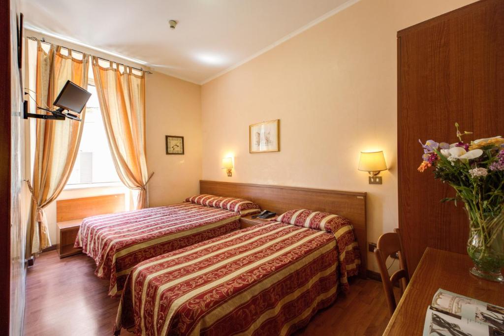 Postel nebo postele na pokoji v ubytování Buonarroti Home