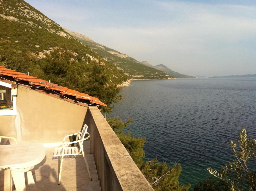 a view of the water from the balcony of a house at Apartments Frog Creek in Slano