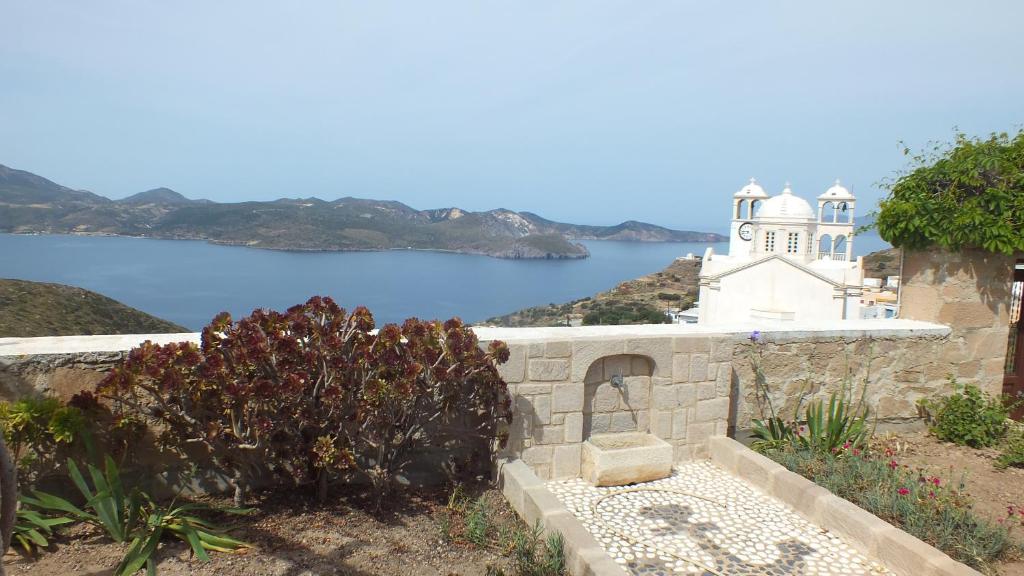 a church with a view of a body of water at Villa de viento in Tripití