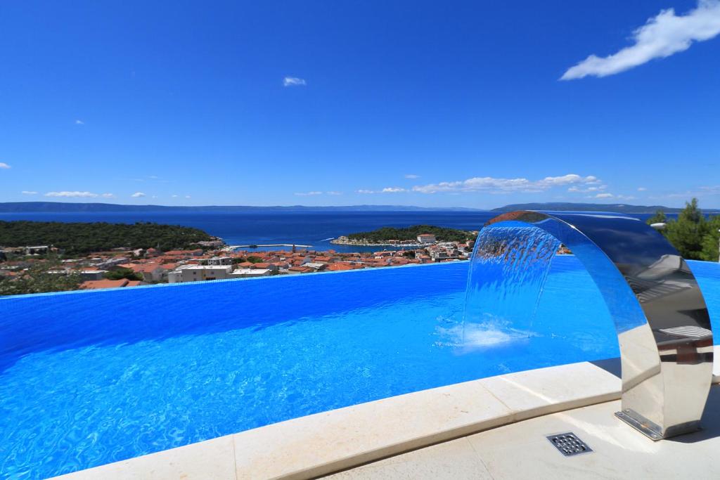 a swimming pool with a water fountain at Villa Afrodita in Makarska