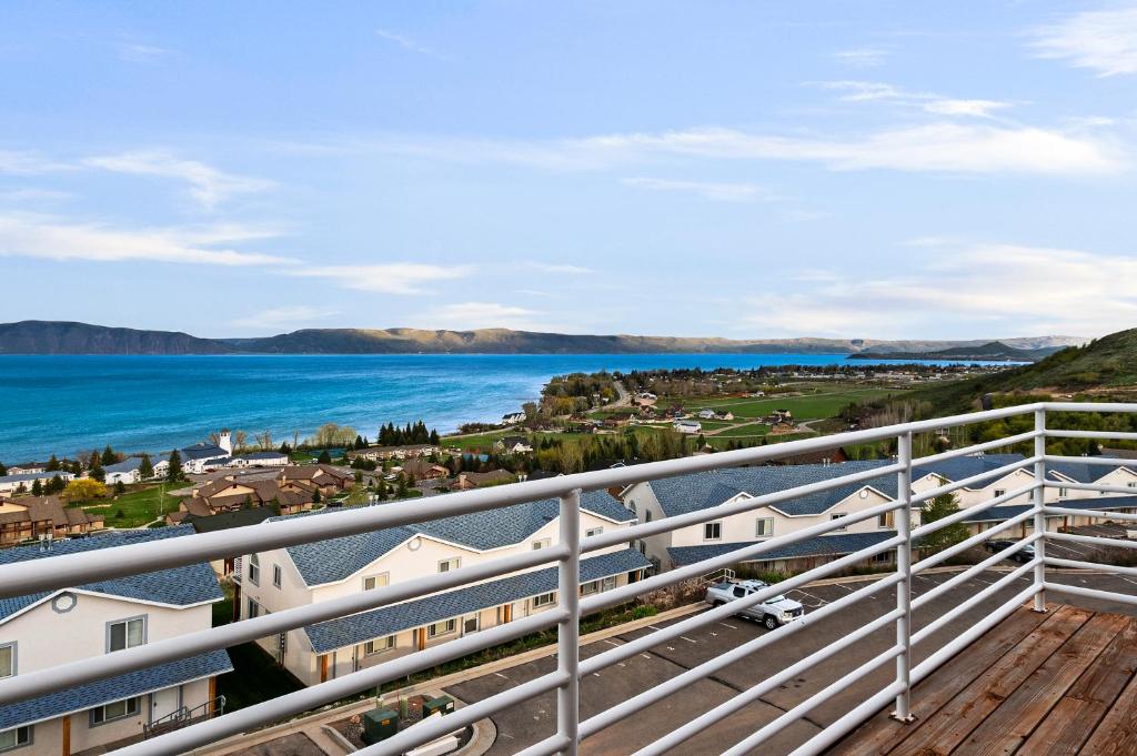 a balcony with a view of the water and houses at Lakeview Condo 941-1 in Garden City