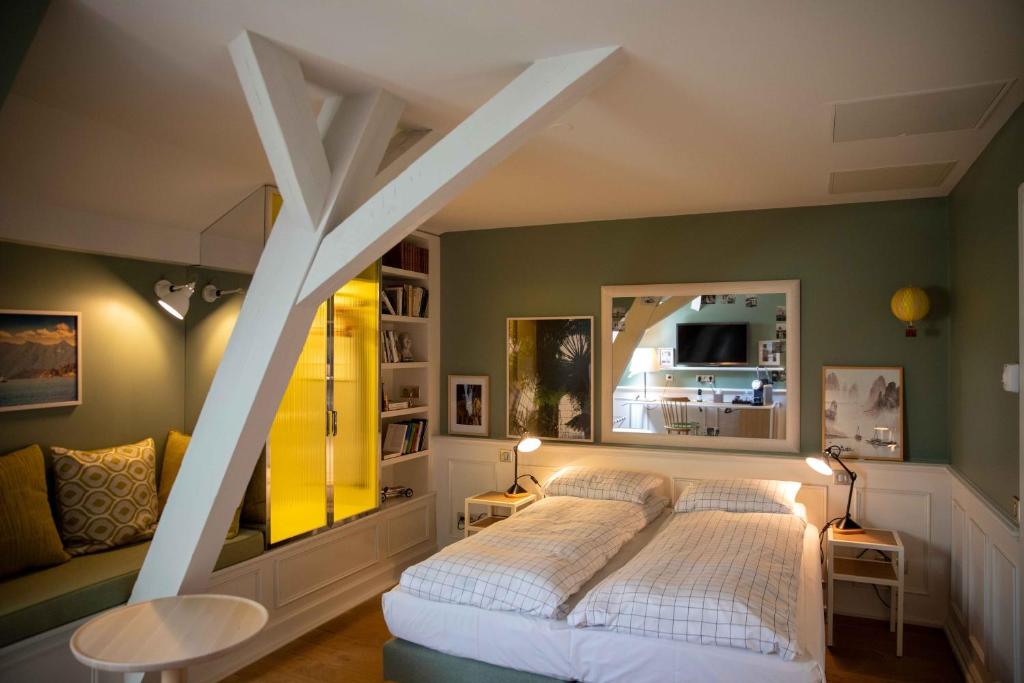 a bedroom with a large white bed in a room at Hôtel et Spa La Villa K - Basel Airport in Saint-Louis
