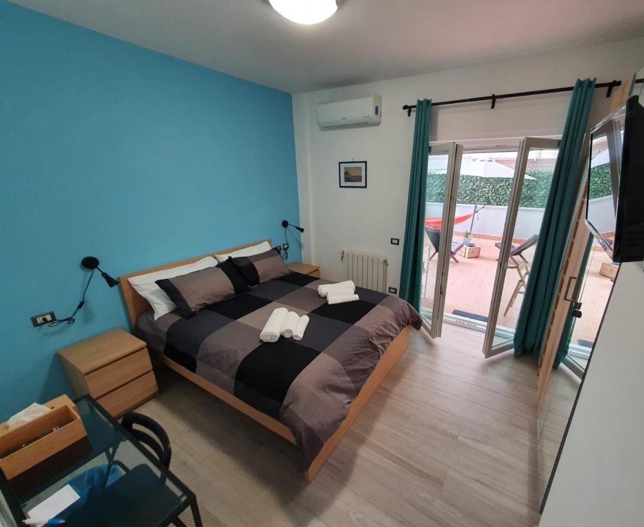 um quarto com uma cama e uma porta de vidro deslizante em @home Napoli em Nápoles