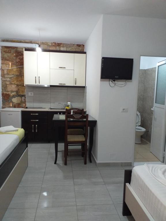 a kitchen with a desk and a table in a room at Grand Seaview Apartments in Ksamil
