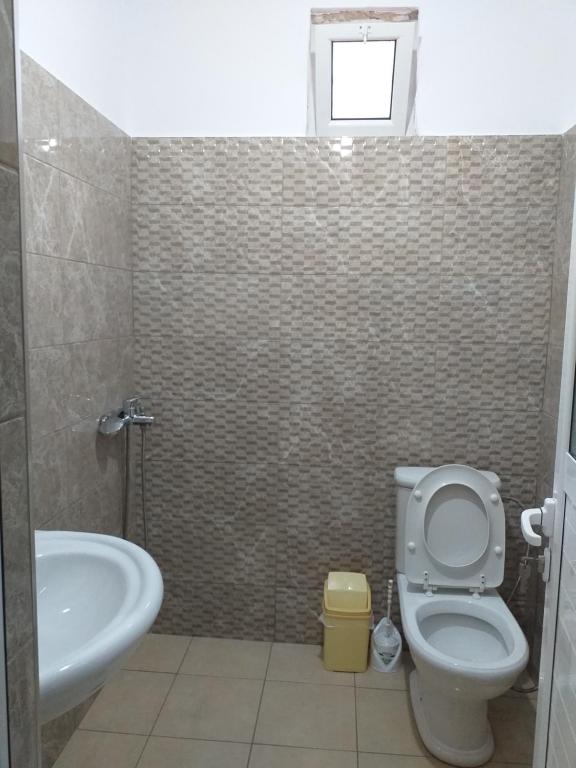 a bathroom with a toilet and a sink and a tub at Grand Seaview Apartments in Ksamil