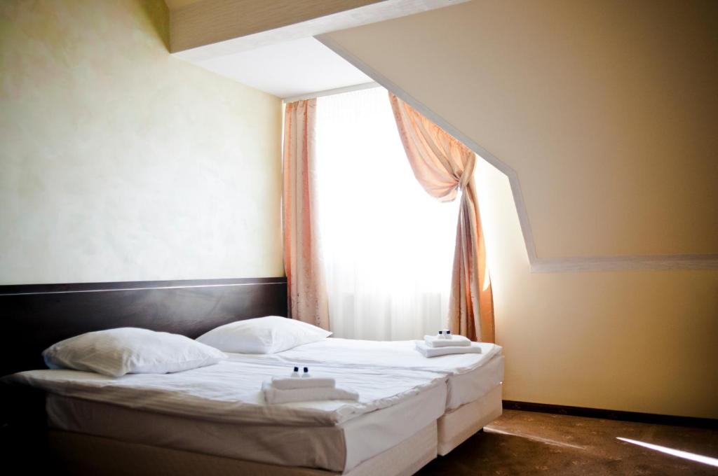 Postel nebo postele na pokoji v ubytování Hotel Oleńka
