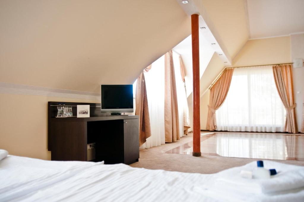 Postel nebo postele na pokoji v ubytování Hotel Oleńka