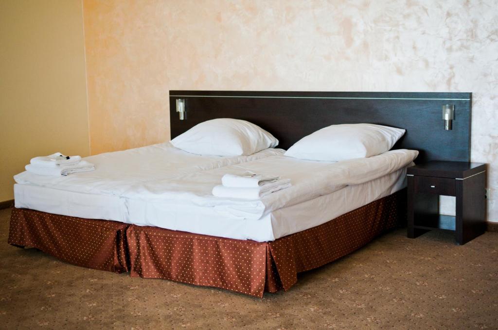 Postel nebo postele na pokoji v ubytování Hotel Oleńka