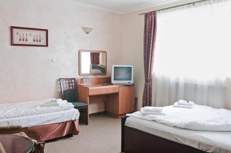 Postel nebo postele na pokoji v ubytování Hotel Oleńka