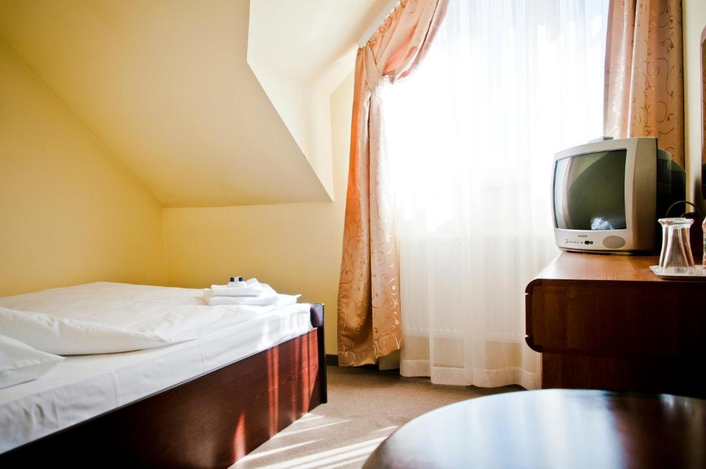 Postel nebo postele na pokoji v ubytování Hotel Oleńka