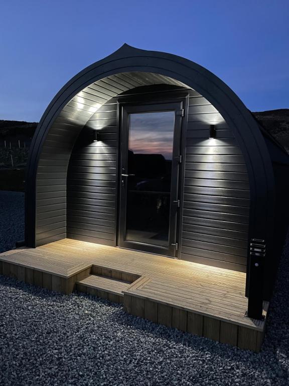 a large garage with a door and stairs in it at Allt Yelkie Pod Coig, Luxury Glamping Earlish in Earlish