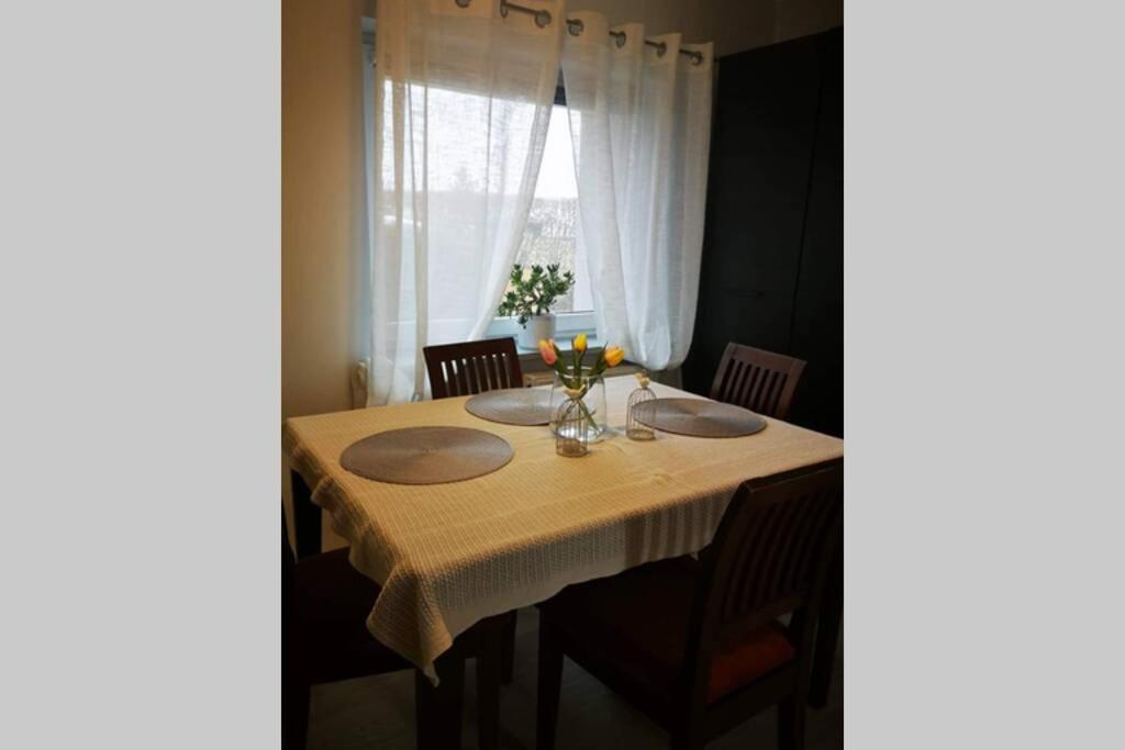 une table à manger avec une nappe jaune dans l'établissement Apartament Mnichowo, à Mnichowo