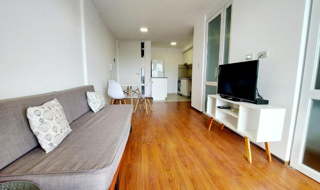 sala de estar con sofá y TV de pantalla plana en 1 dormitorio - zona Pichincha - Nuevo en Rosario