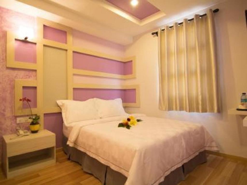 Postel nebo postele na pokoji v ubytování Sunshine Inn Plus