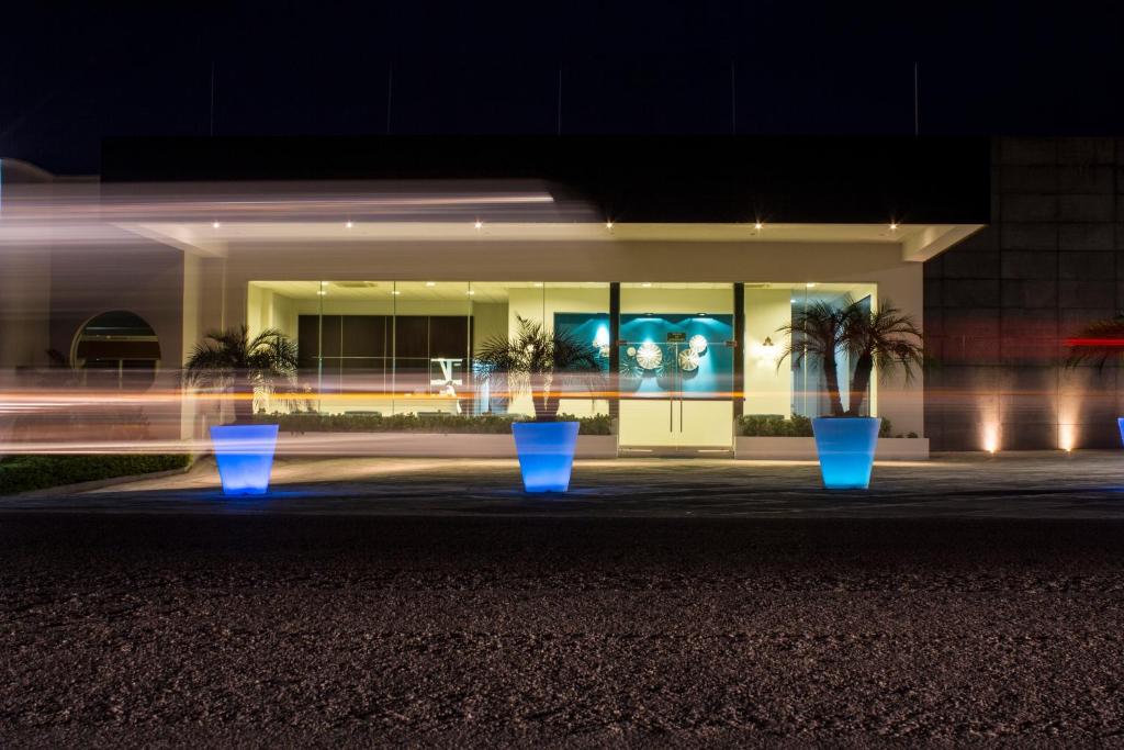 a building with blue pots in front of it at night at Hotel Aqua Spa & Resort in Martínez de La Torre