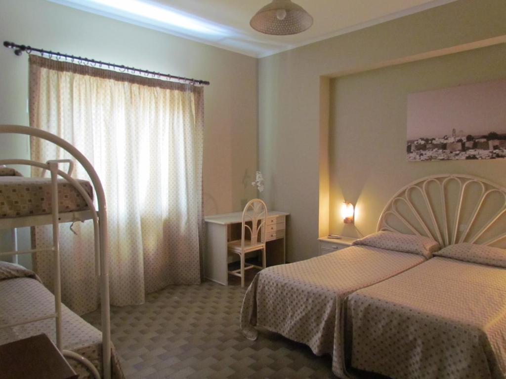 Postel nebo postele na pokoji v ubytování Pietra Pomice Hotel