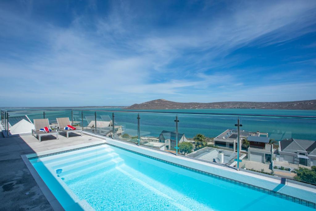 a swimming pool with a view of the ocean at THE VIEW LANGEBAAN LAGOON VILLA WITH HEATED POOL and SOLAR ENERGY in Langebaan