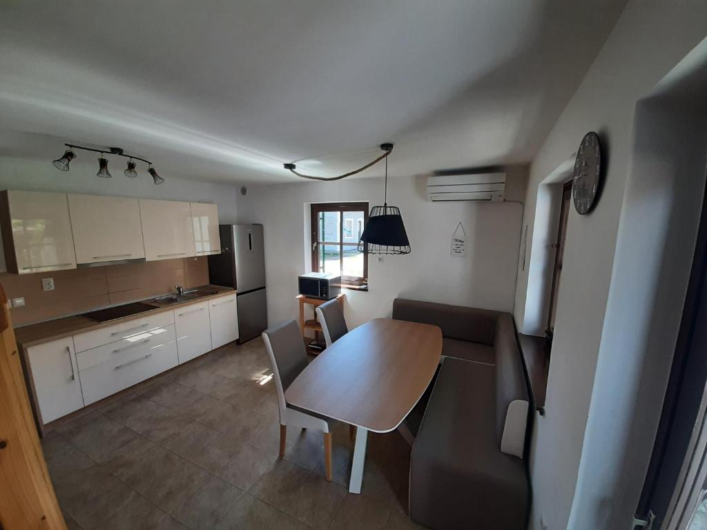 a kitchen with a table and a dining room at Apartment Terme Čatež VIP 145 in Brežice