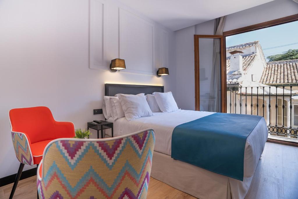 Postel nebo postele na pokoji v ubytování Hotel Boutique Puerta de las Granadas