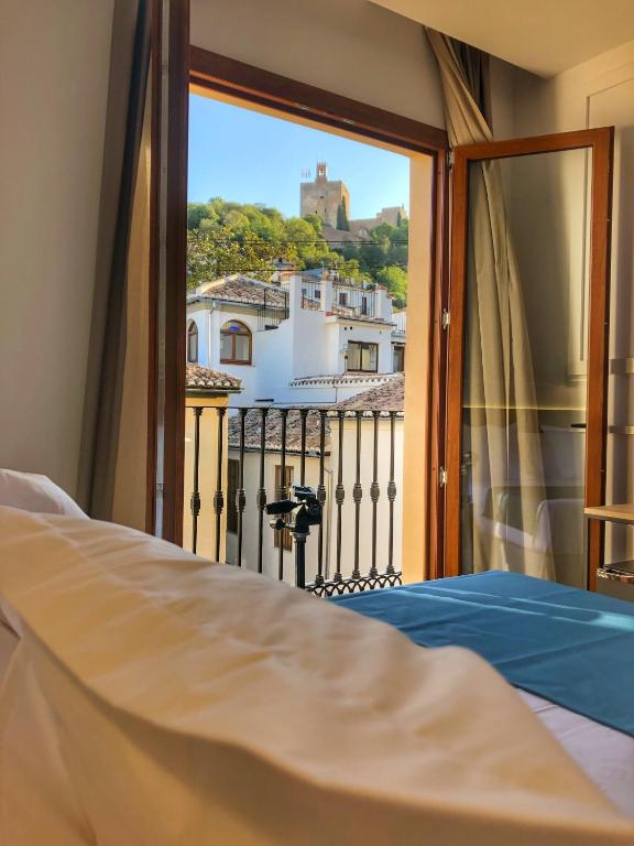 Postel nebo postele na pokoji v ubytování Hotel Boutique Puerta de las Granadas